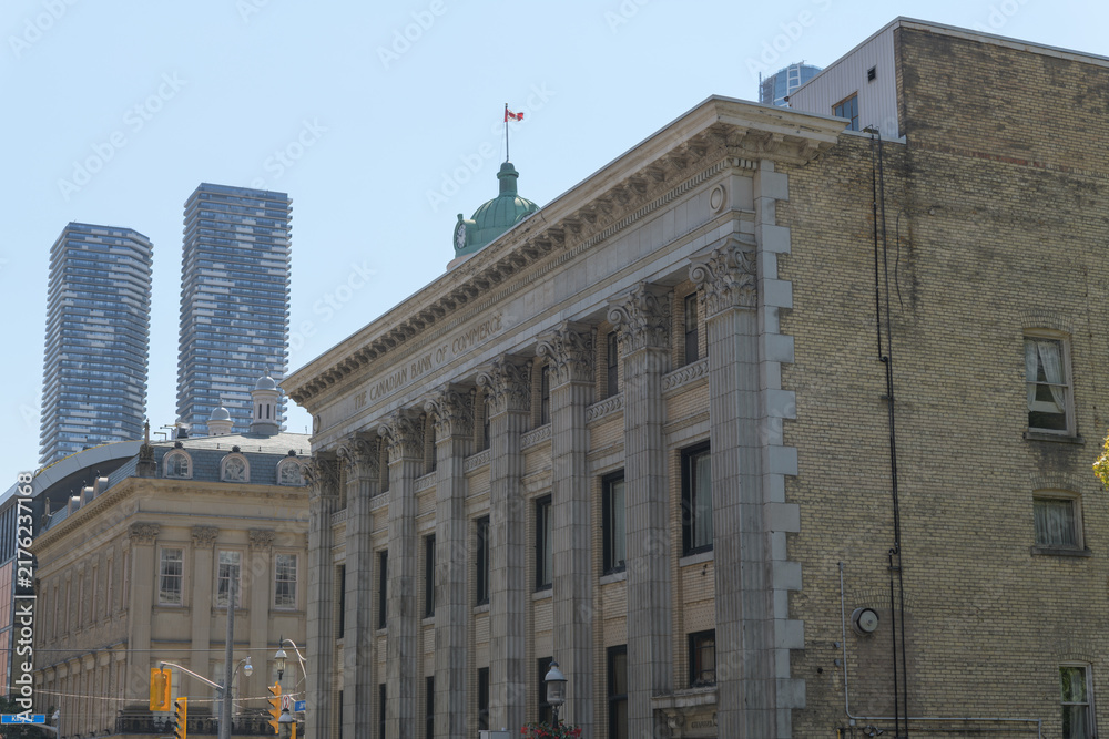 Obraz premium architecture profiles at Jarvis St and King St E, Toronto: Bank of Commerce (Darling & Pearson, 1907) and St Lawrence Hall (William Thomas, 1850)