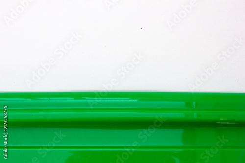 Obraz na plátne Abstract two-tone background with a green ribbed texture and white space