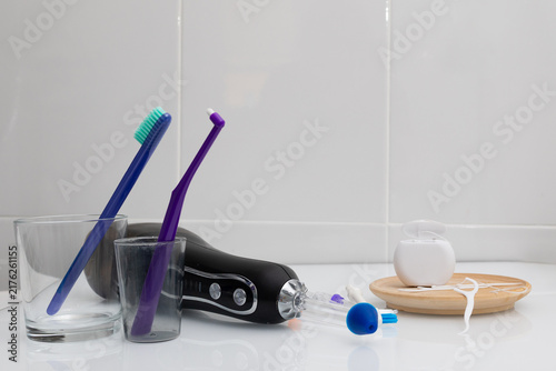 Canvastavla Daily dental care routine with toothbrushes, flossers, floss, and irrigator on bathroom counter