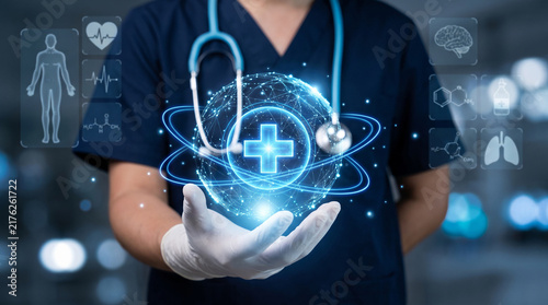Doctor holds glowing digital medical cross globe with health icons, futuristic healthcare concept