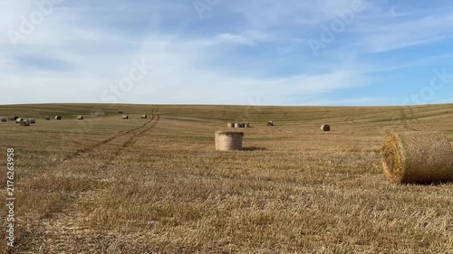 Hay Bales On Stubble Field Under Blue Sky Video