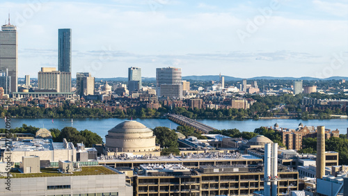 Aerial view of the MIT Great Dome and campus buildings, with the Charles River and Boston skyline in the background in Cambridge, Massachusetts, United States.