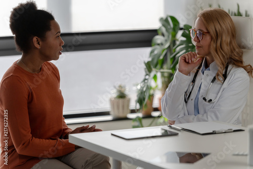 Doctor and patient having an attentive face-to-face conversation, representing patient-centered care and communication in healthcare