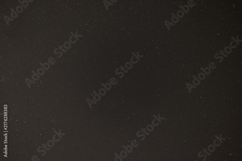 Starry Night Sky Background with Faint Meteor Trails and Deep Space Stars