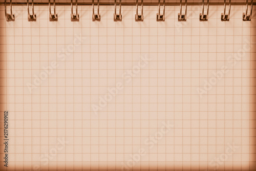 Obraz na plátně blank sheet of aged copybook with metallic spiral binder and squared paper