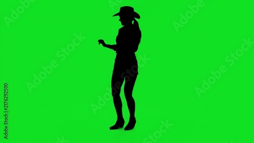 Silhouette of a cowgirl dancing happily on a green screen chroma key background