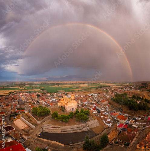 Foto Arco iris con pueblo a vista aérea con iglesia