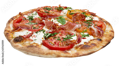 Fresh artisanal pizza with prosciutto sliced tomatoes, mozzarella and basil