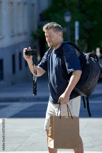 Male tourist traveling and capturing city street scene