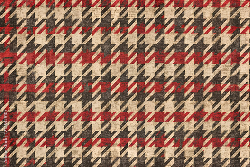 Geometric herringbone pattern with distressed effect in red. beige. and dark brown.