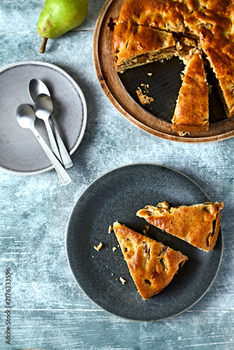 Homemade pear cinnamon cake slices on a plate with fresh fruit