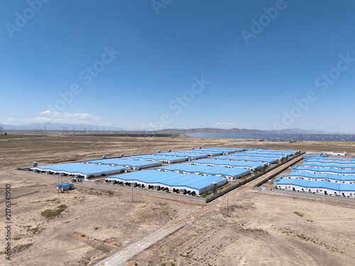 Фотография rows of blue roof temporary buildings in desert area