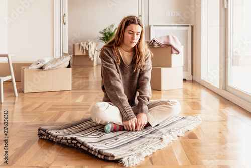 Young woman feeling mental load and sadness during house move