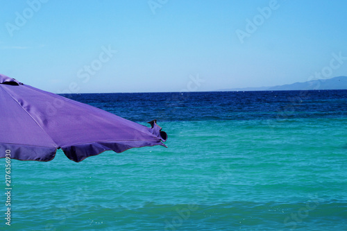 Parasol on the beach with the sea in the background