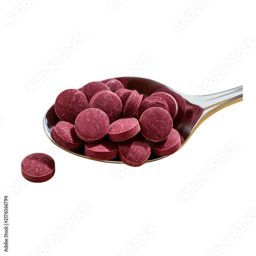 Deep magenta circular chewable tablets on spoon isolated on transparent background PNG element