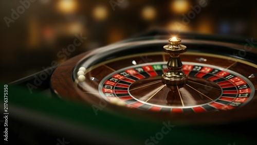Close-up of a roulette wheel with a shiny metallic spinner in a casino setting