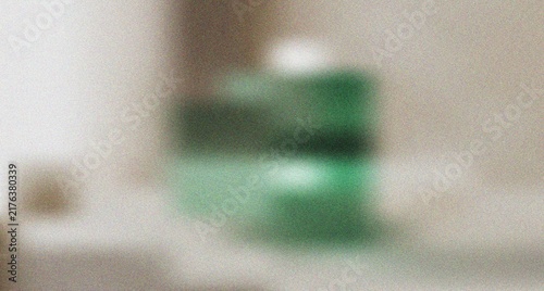 Fotografie Mysterious blurry green container on a subtle neutral surface with a distinct sm