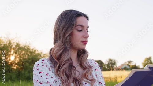 Engaging in Reading in Nature Beautiful Woman with a Book in a Field
