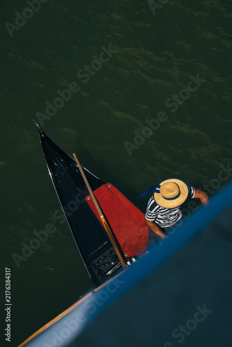 Foto Gondolier seen from above on a Venetian canal in Venice, Italy