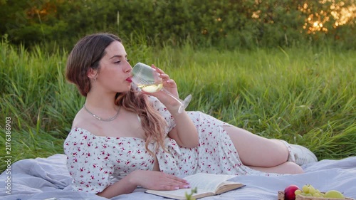 Enjoying a Relaxing Picnic in Beautiful Nature with a Book and Wine