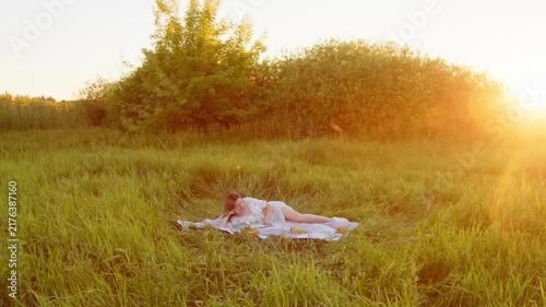 A Serene Woman Enjoying a Relaxing Moment in a Sunsetlit Field of Grass