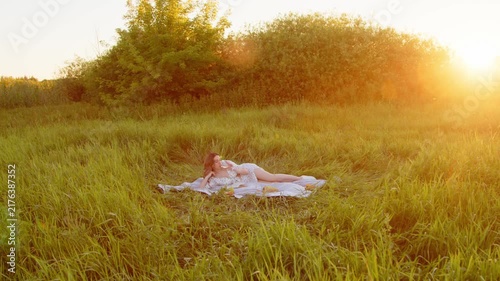 A Serene Woman Enjoying Relaxation in Nature During a Beautiful Sunset