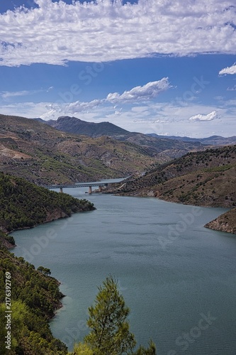Rules reservoir in spain with bridge crossing guadalfeo river