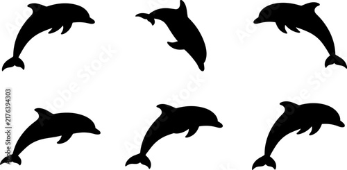 Set of black silhouettes of dolphins jumping and swimming