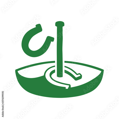 Green horseshoes game vector icon with flying horseshoe and stake in pit for outdoor recreation design