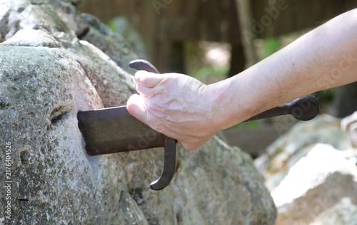 Cuadro en lienzo Hand of a man trying to pull the legendary Excalibur sword from