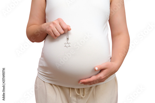Canvastavla Pregnant woman holding Star of David pendant over her belly