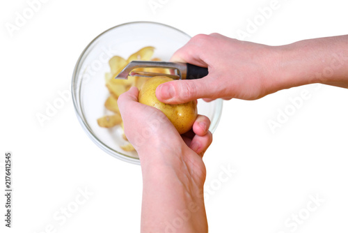 Bild auf Leinwand Person peeling fresh raw potato with professional metal peeler over glass bowl isolated on transparent background
