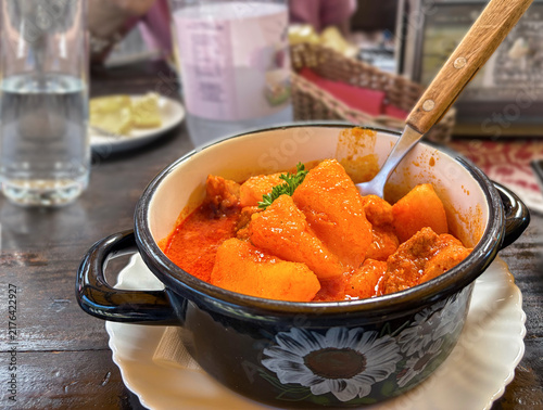 Traditional Hungarian goulash served in a small cooking pot