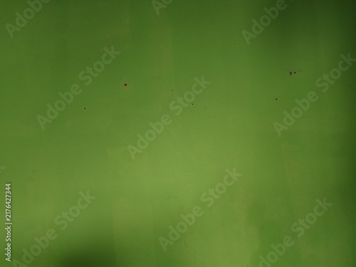 Foto solid green painted wall texture with minor blemishes