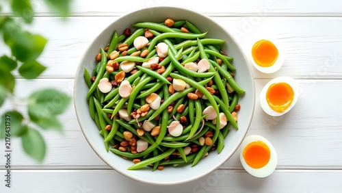 Fresh green bean salad served with boiled eggs and nuts