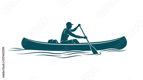 Silhouette of Man canoeing on tranquil water.