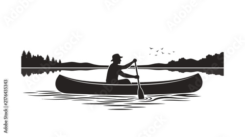 Silhouette of person canoeing on calm lake at sunset with reflection and treeline