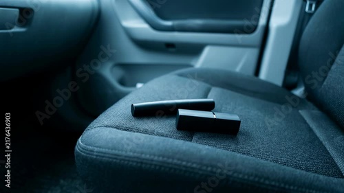 Lipstick left on car seat as evidence of infidelity. Abandoned cosmetic item revealing secret affair. Broken trust in marriage, suspicion, and hidden betrayal.