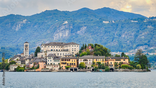 Panoramic view of San Giulio Island on Lake Orta, Piedmont, Italy, featuring the historic basilica and picturesque lakeside scenery surrounded by Alpine landscapes