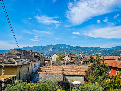 Panoramic view of Orta San Giulio on the shores of Lake Orta, Piedmont, Italy. Aerial drone view showcasing the historic lakeside town and picturesque Alpine landscape