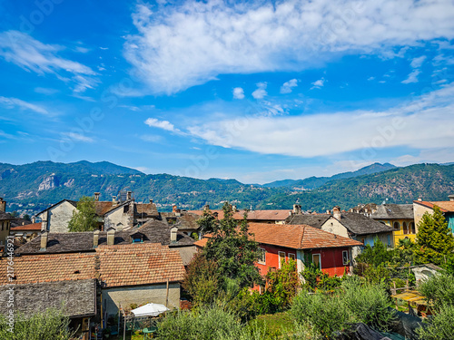 Panoramic view of Orta San Giulio on the shores of Lake Orta, Piedmont, Italy. Aerial drone view showcasing the historic lakeside town and picturesque Alpine landscape