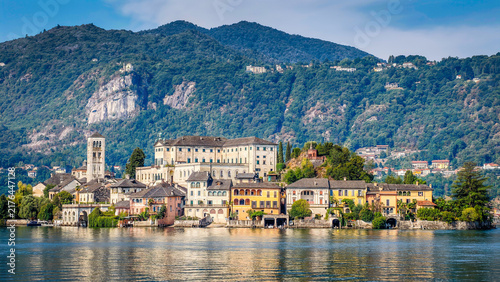 Panoramic view of San Giulio Island on Lake Orta, Piedmont, Italy, featuring the historic basilica and picturesque lakeside scenery surrounded by Alpine landscapes