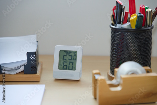 Office Desk Close-Up with Thermometer and Desk Accessories