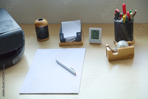Office Desk Close-Up with Thermometer and Stationery