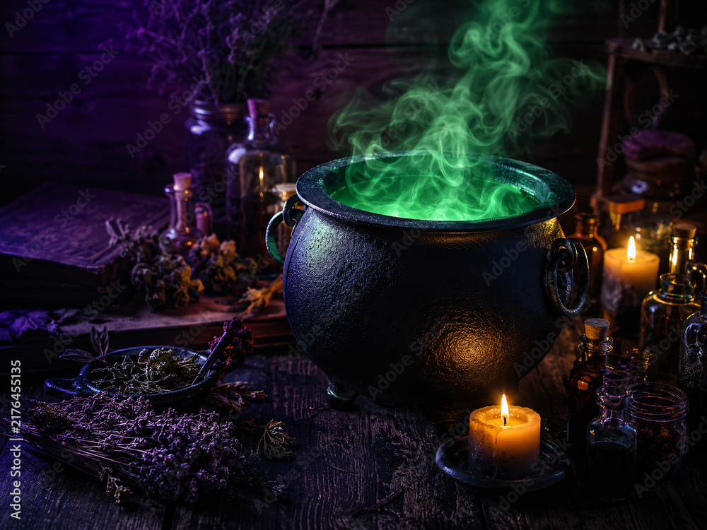 Fototapeta premium Witch's cauldron brewing a glowing green magic potion with smoke, herbs, and candles.