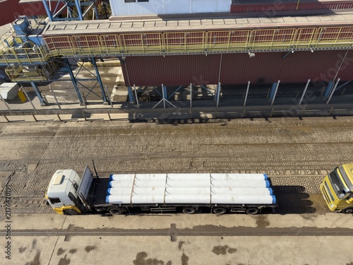 Fotografía heavy truck with big pipes loaded to long trailer aerial view.