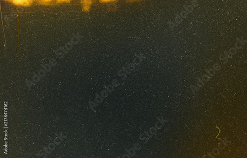 Foto Dark Film Grain Texture with Golden Film Burn, Heavy Dust, and Vertical Edge Scr