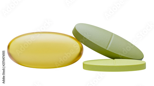 Cuadro en lienzo Yellow oval capsule and two green oblong pills, isolated on transparent backgrou