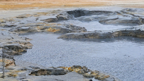 Konstfotografi Close-up view of a geothermal pool at Hverir in Iceland, surrounded by eroded volcanic ground, mineral deposits, and steaming geothermal terrain