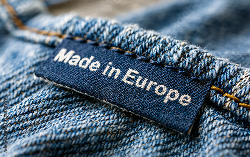Blue clothing label with Made in Europe text on knitted fabric
